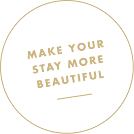Brown circle with the text MAKE YOUR STAY MORE BEAUTIFUL in bold capital letters inside.